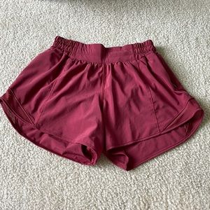 Lululemon Hotty Hot shorts low-rise 4 in. Color is burgundy.